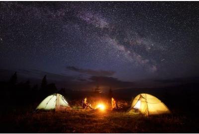 Two tents outside at night under the stars.