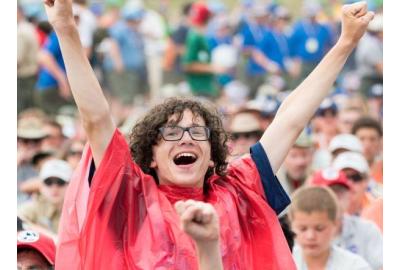 Scout in a red poncho cheering at the 2017 National Scout Jamboree