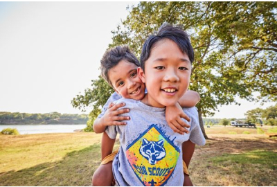 Two Cub Scouts pose for a picture in matching Cub Scout tees.
