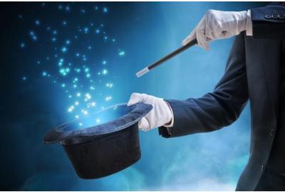 A magician waving a wand performing hat trick.