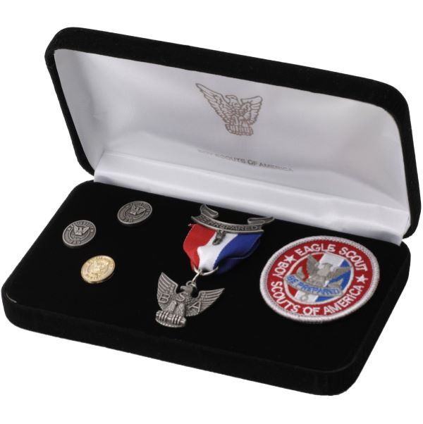 Eagle Scout Award Kit with Antique Finish Medal, Emblem, Pins, and Display Box Eagle Scout Award Kit with Antique Finish, including a medal with red, white, and blue ribbon, cloth rank emblem, parent pins, mentor pin, and a presentation box.