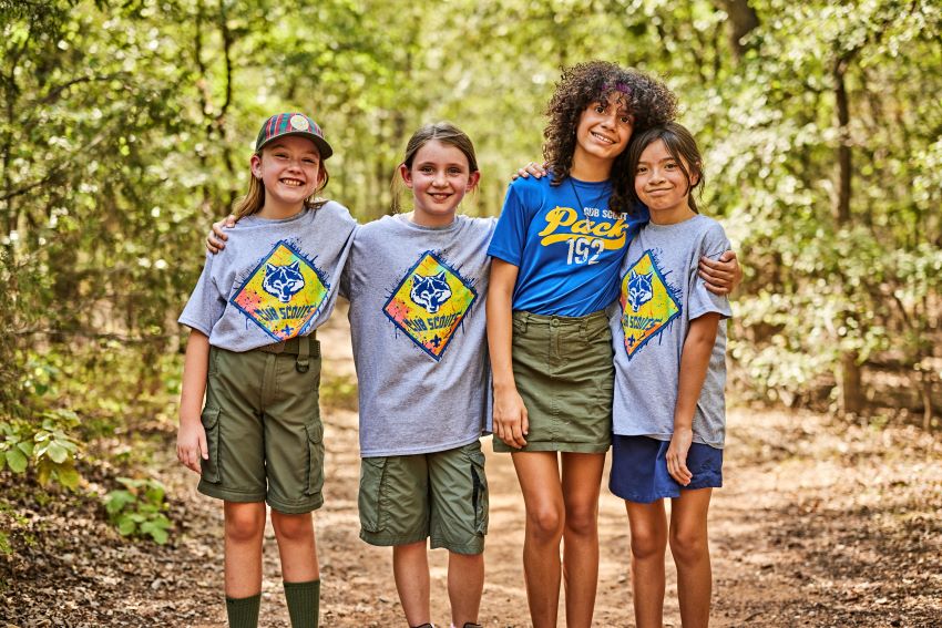 Four Cub Scout girls pose for a picture in gray Cub Scout tees.