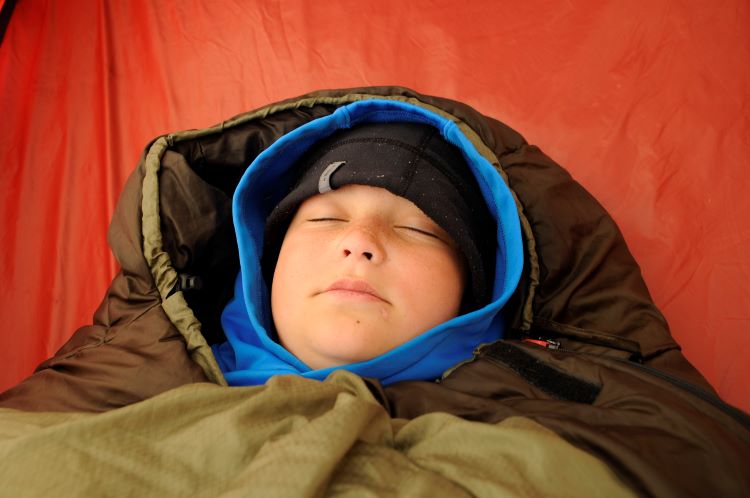 Boy Scout sleeping in a mummy sleeping bag