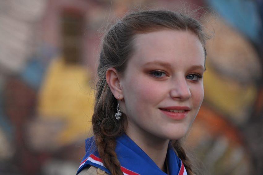 Scout Leadership and Confidence | Inspiring Youth Through Scouting Values. Close-up of a smiling Scout in uniform, showcasing leadership and pride against a colorful background.