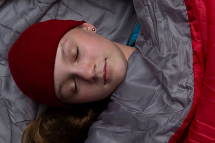 Girl Scout sleeping in a sleeping bag