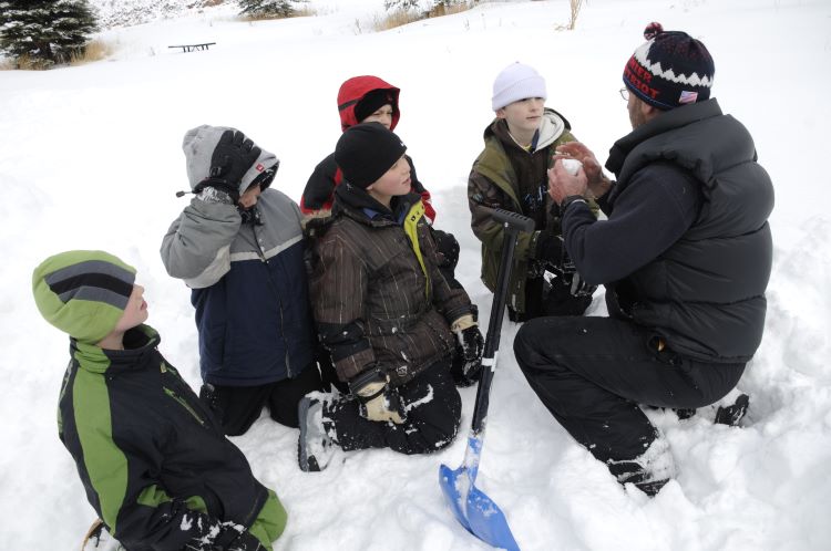 Winter Camping Snow Scoutmaster talks to Scouts on a winter camping trip in the snow