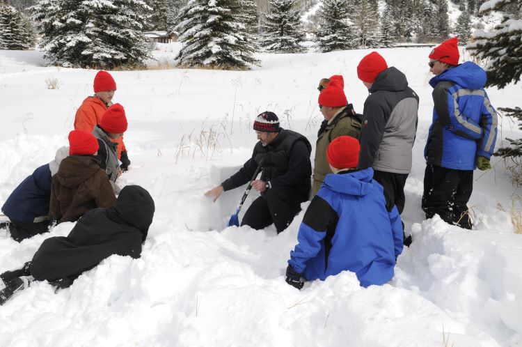 Scouts set up a winter tent in the snow