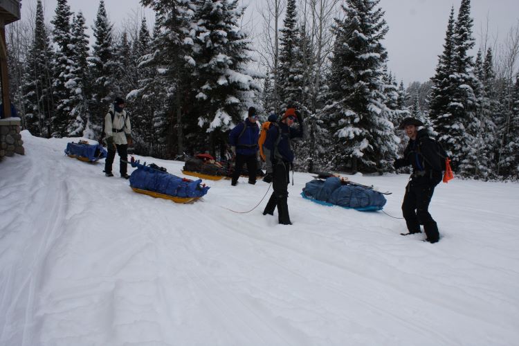 Scouts pulling a sled in the snow