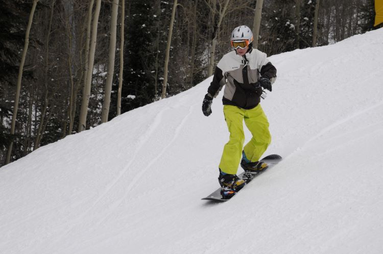 Scout snowboarding down a slope