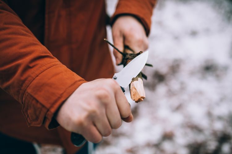 Scout sharpening a pocket knife