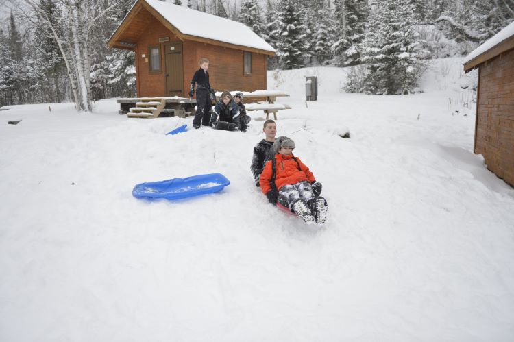 Scouts sled down a slope